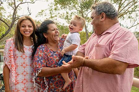 happy mother and grandparents visit with their birth child