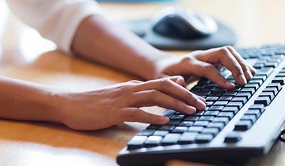 woman typing on computer